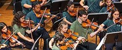 young people playing violins