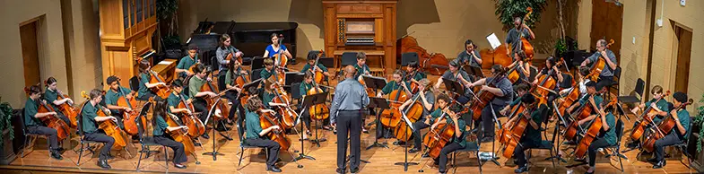 young people playing cellos