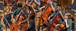 young people playing cellos