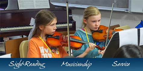 2 girls playing violins