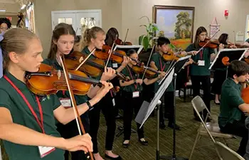 young people playing violins