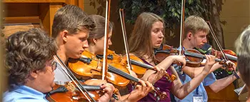 young people playing violins